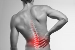 Picture of man clutching his lower back in pain