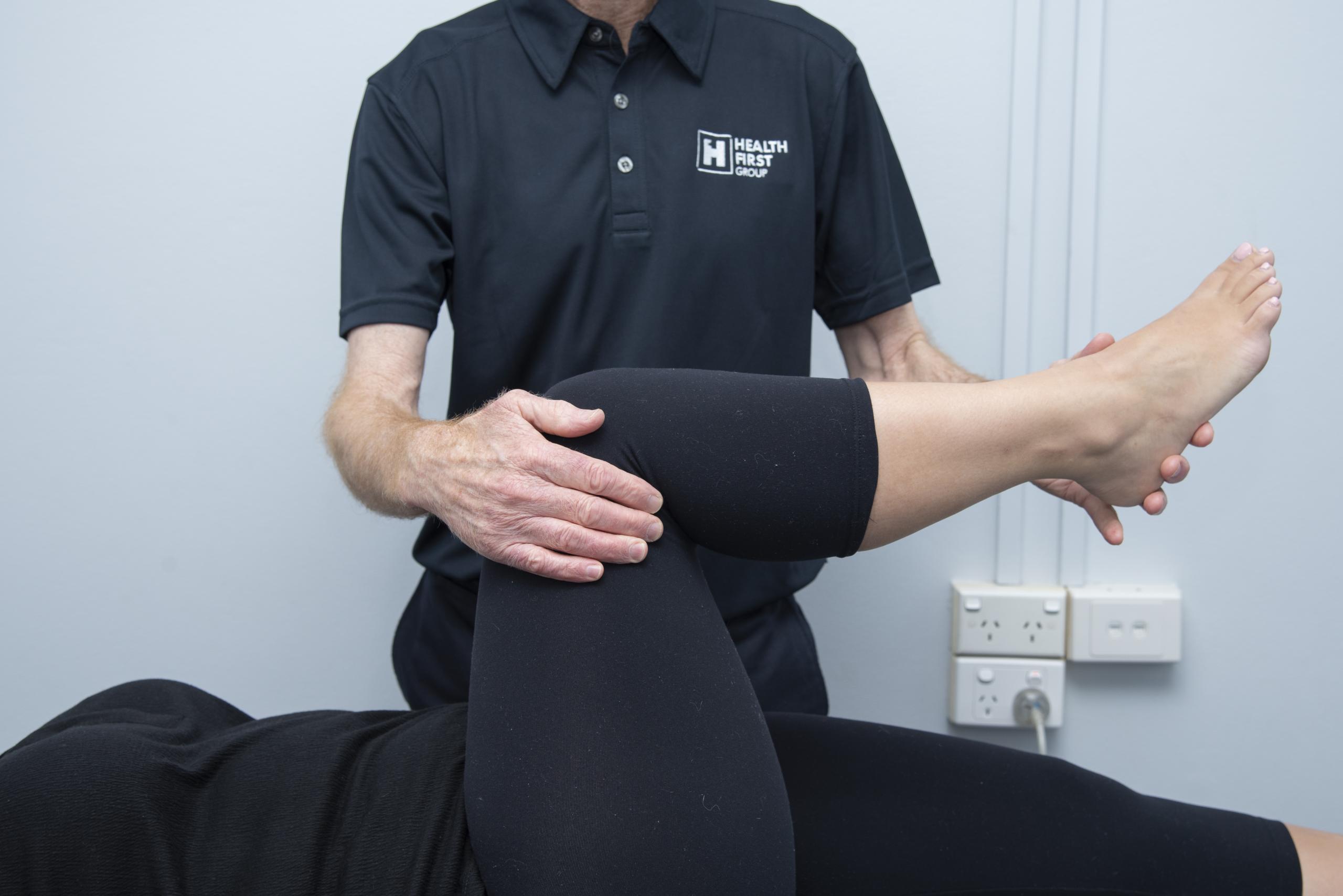Physio providing manual therapy for a patient with knee pain