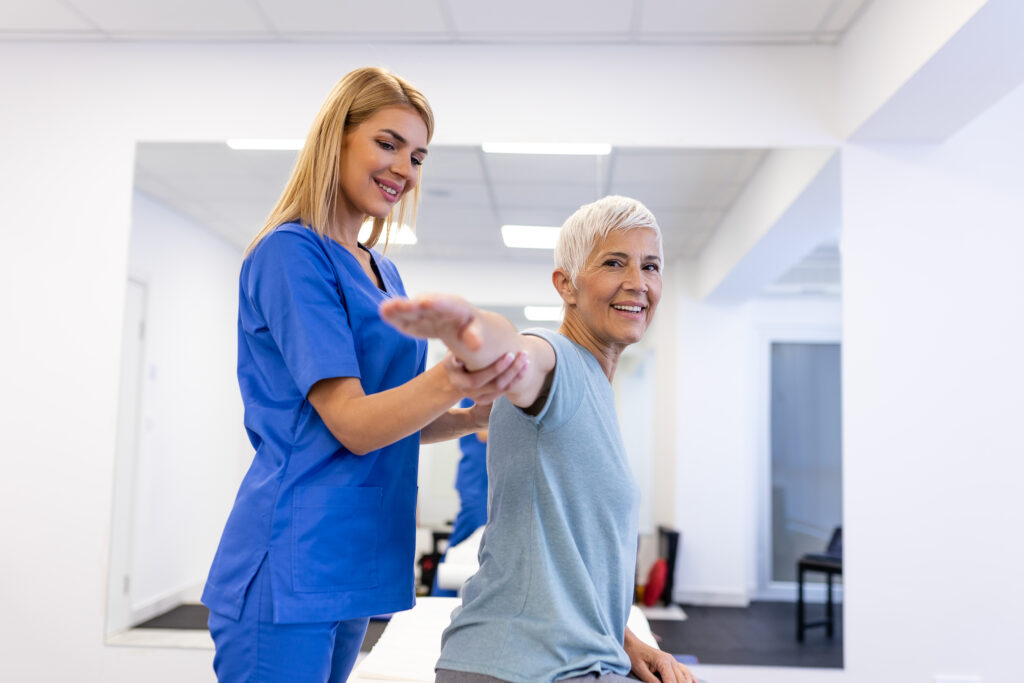 Health professional assisting older woman with functional capacity assessment in a clinical setting, highlighting personalized care and support for daily activities.
